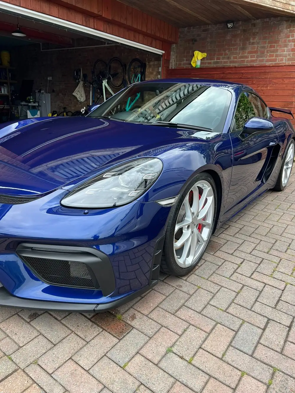 Blue Porsche 718 Cayman GT4 after a machine polish